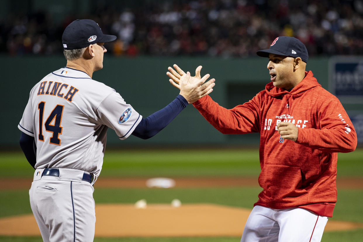 BOSTON, MA - OCTOBER 13: Manager Alex Cora of the Boston Red Sox high fives manager A.J. Hinch of the Houston Astros before game one of the American League Championship Series on October 13, 2018 at Fenway Park in Boston, Massachusetts. (Photo by Billie Weiss/Boston Red Sox/Getty Images)