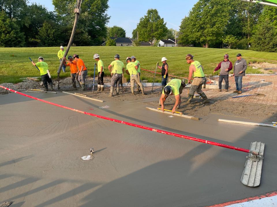 Workers from Sloan Concrete pour a slab that will be the future home of RJ's Spray Park at the Salvation Army’s Ashland Kroc Center.