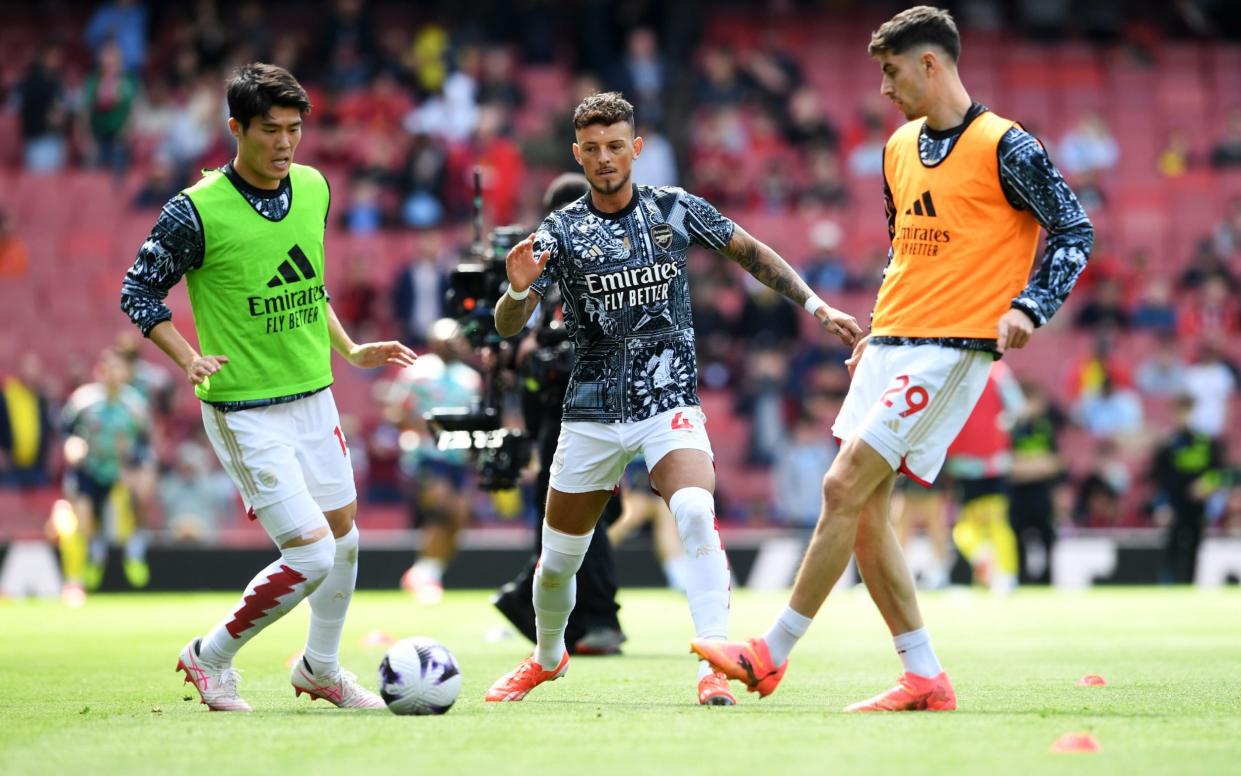 Takehiro Tomiyasu, Ben White and Kai Havertz of Arsenal warm up