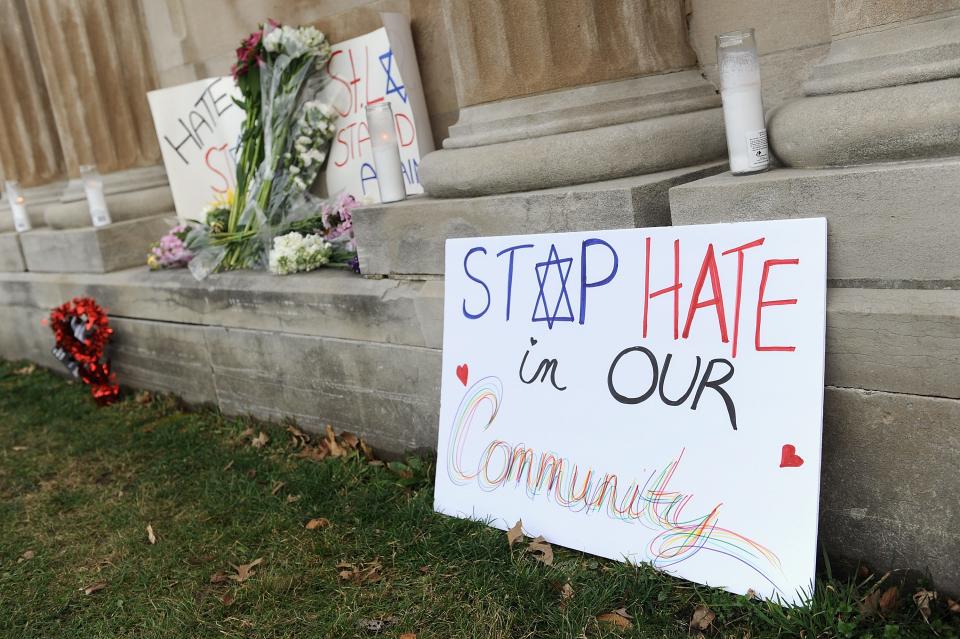 Signs were displayed outside Chesed Shel Emeth Cemetery in February 2017 in University City, Missouri, where several hundred volunteers had cleaned up after vandalism at the cemetery, part of a nationwide spike in incidents, including bomb threats at Jewish community centers and reports of anti-semitic graffiti.