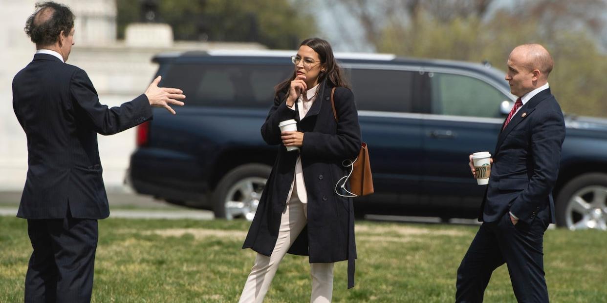 From left, Reps. Jamie Raskin, D-Md., Rep. Alexandria Ocasio-Cortez, D-N.Y., and Max Rose, D-N.Y., talk outside the Capitol before the House passed a $2 trillion coronavirus aid package by voice vote on Friday, March 27, 2020.