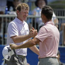 Brandt Snedeker, left, is congratulated by playing partner Billy Horschel, right, after finishing their round on the ninth hole during the first round of the Wyndham Championship golf tournament in Greensboro, N.C., Thursday, Aug. 16, 2018. Sneaker shot a 59 in the first round. (AP Photo/Chuck Burton)