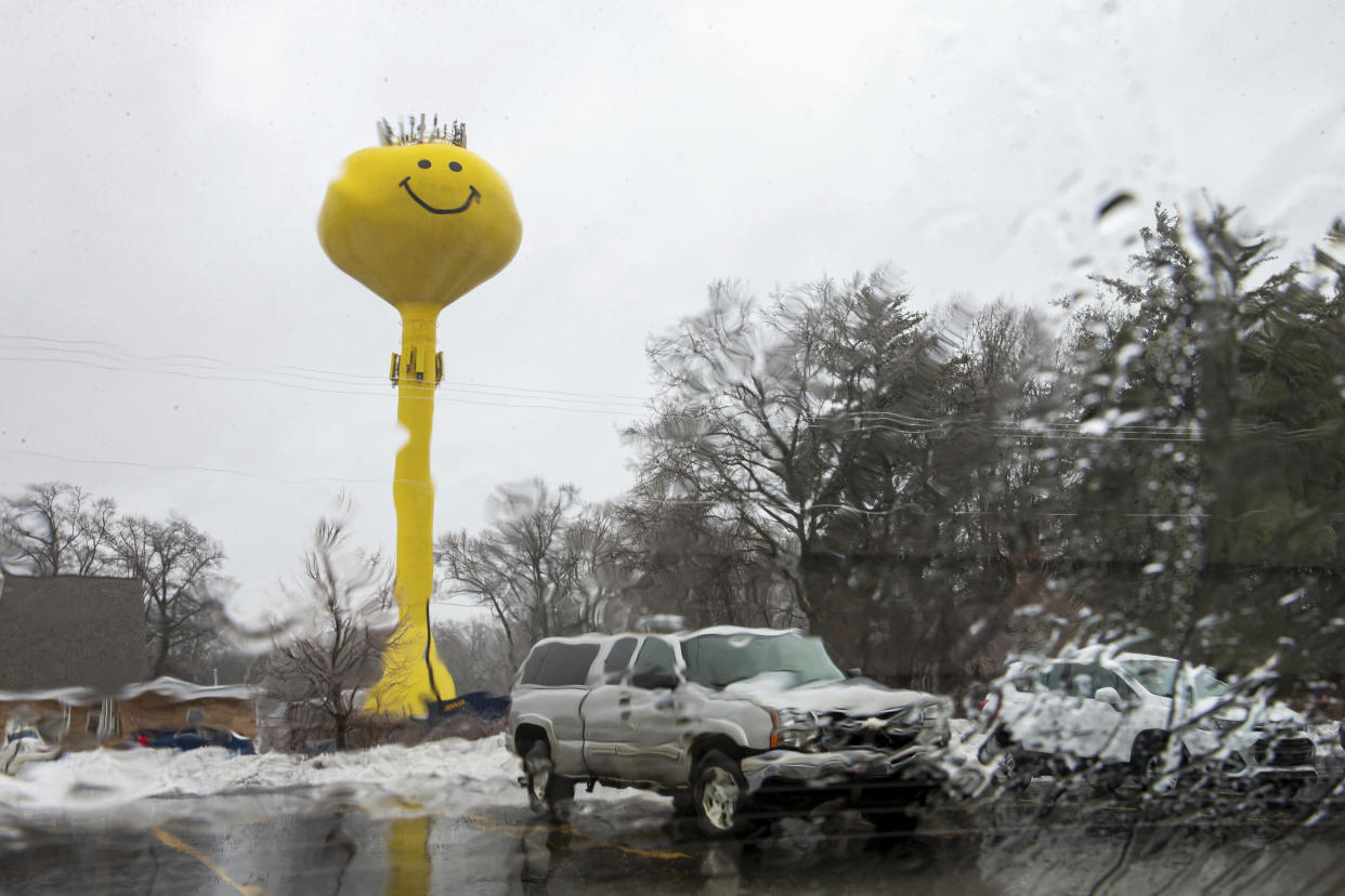 The "Smiley Face" water tower in Fruitport Township, Mich., is pictured through a window in freezing rain on Monday, Feb. 27, 2023. (Cory Morse/MLive.com/The Grand Rapids Press via AP)