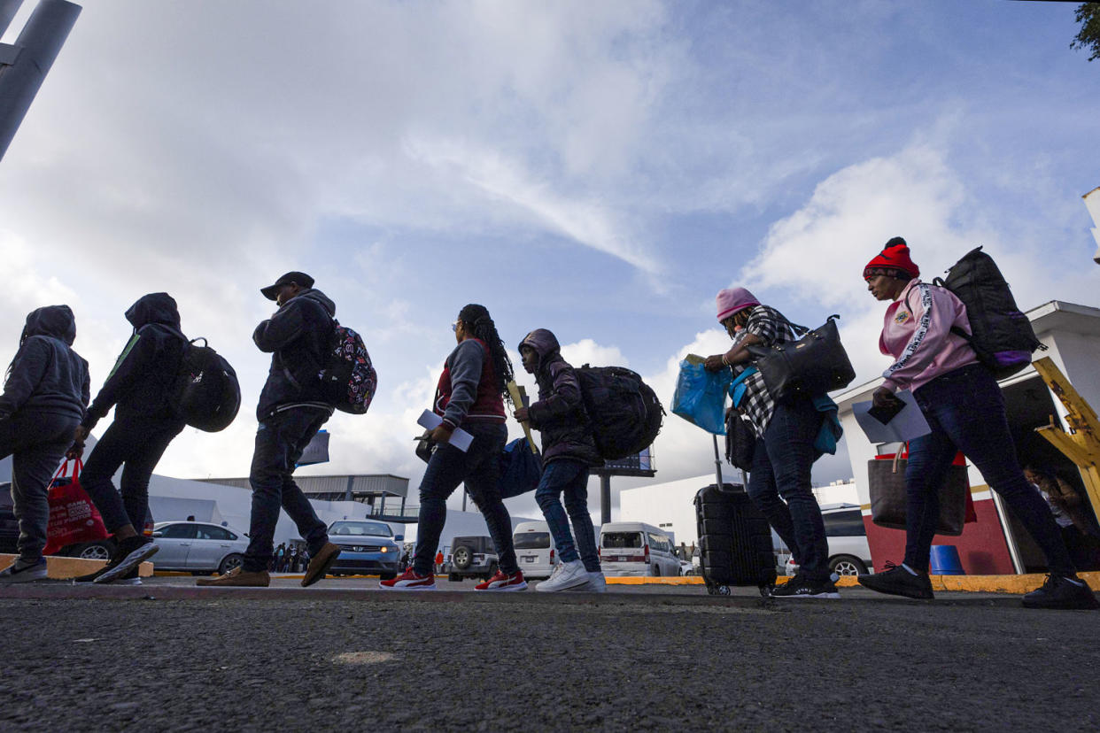 People, including many Haitians, leave Mexico to cross into the United States (Gregory Bull / AP file)