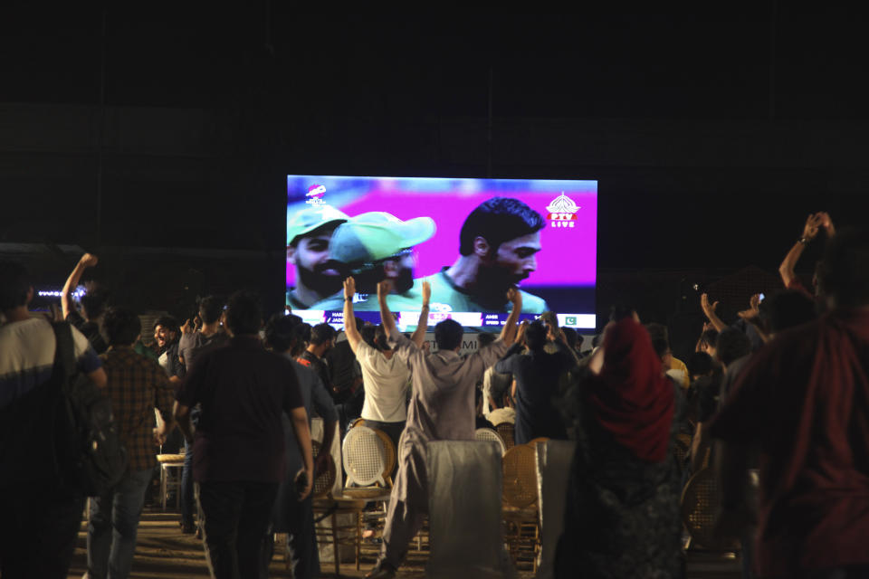 Pakistani cricket fans watch the ICC Men's T20 World Cup cricket match between India and Pakistan on a big screen in Karachi, Pakistan, Sunday, June. 9, 2024. (AP Photo/Ikram Suri)