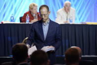 Dr. Jared Wellman, pastor at Tate Springs Baptist Church in Arlington, Texas, hands out copies of his motion during the executive committee plenary session at the denomination's annual meeting Monday, June 14, 2021, in Nashville, Tenn. Wellman's motion called for an independent committee to lead a probe of the denomination's handling of sex abuse cases. (AP Photo/Mark Humphrey)