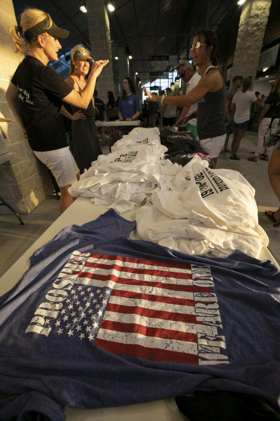 Shirts for sale during the opening of the new Children's Health Stadium at Prosper ISD on Saturday, Aug. 17, 2019 in Prosper, Texas. Democrats are out to show they’re serious about flipping Texas in 2020 by holding Thursday’s presidential debate in Houston. Republicans are coming off their worst election in Texas in a generation. Fast-changing suburbs are trending more liberal, and Democrats are counting on more left-leaning voters moving in to turn the state blue. But that transformation may not arrive by 2020, and the GOP is closely watching conservative bastions like the booming Dallas suburbs. (AP Photo/Nathan Hunsinger)