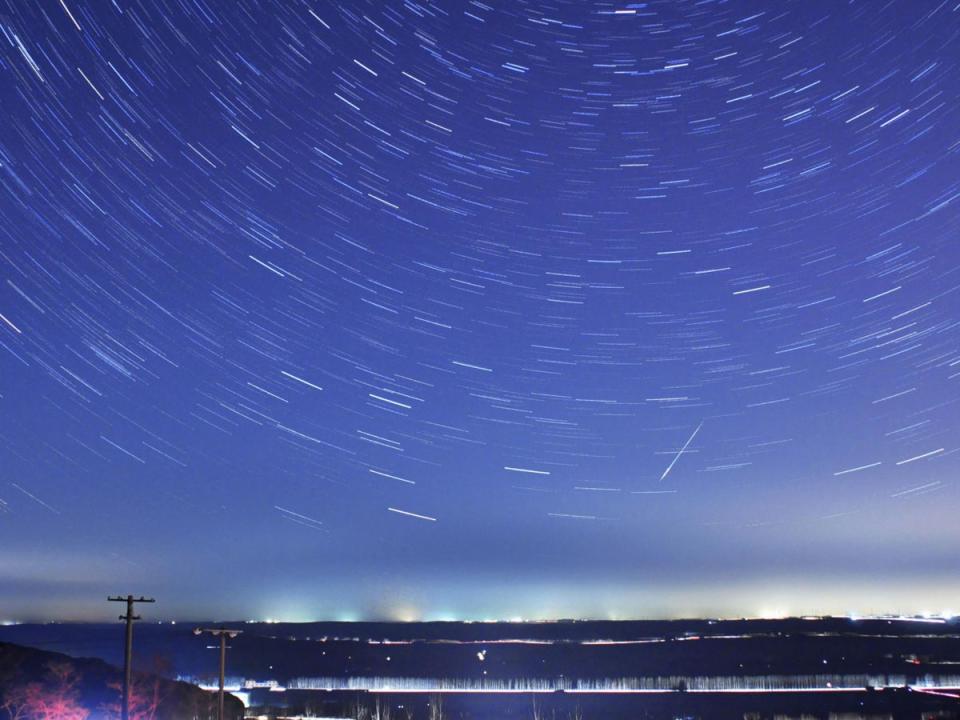 A meteor streaks past stars during the annual Quadrantid meteor shower (Reuters)