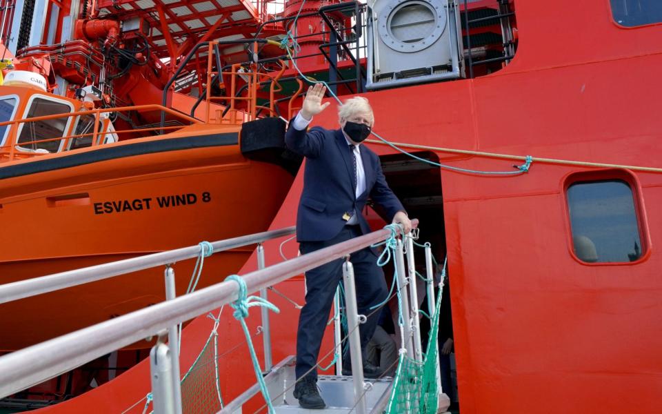 Boris Johnson waves as he boards the vessel Alba in Fraserburgh Harbour, Aberdeenshire - PA