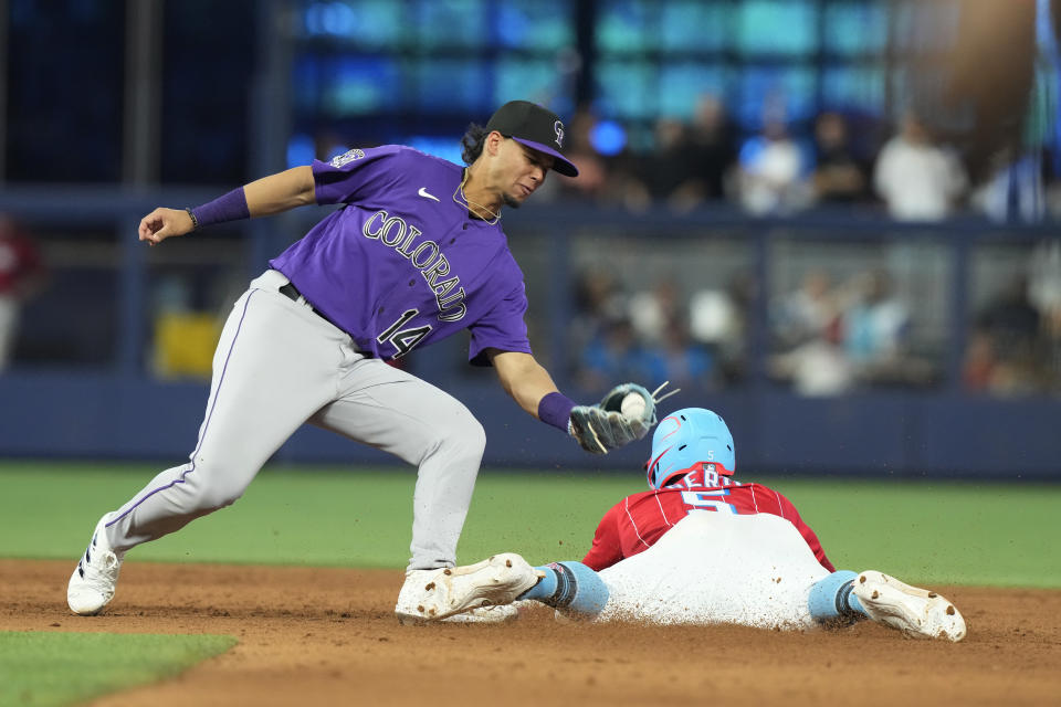 Miami Marlins' Jon Berti (5) steals second base as Colorado Rockies shortstop Ezequiel Tovar (14) is late with the tag during the seventh inning of a baseball game, Saturday, July 22, 2023, in Miami. (AP Photo/Marta Lavandier)