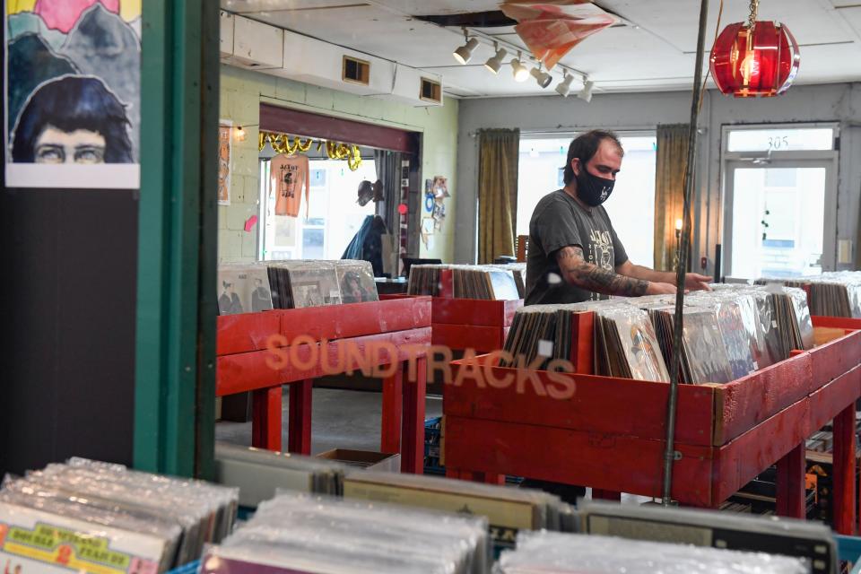 Dan Nissen organizes vinyl records on Tuesday, April 27, 2021, at Total Drag, a record shop in Sioux Falls.