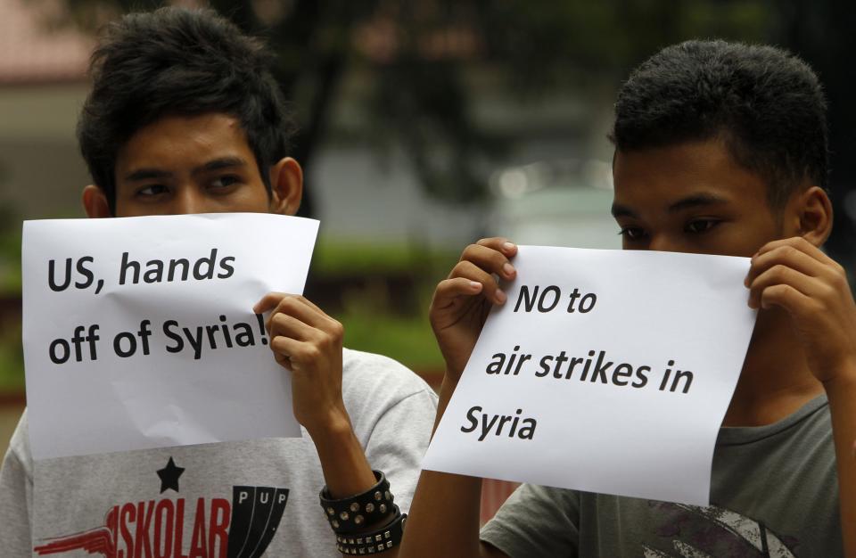 Student activists hold signs during a protest at a university campus in Manila September 5, 2013 to denounce U.S. President Barack Obama's proposed plan for a limited military strike in Syria. REUTERS/Romeo Ranoco (PHILIPPINES - Tags: POLITICS MILITARY CIVIL UNREST CONFLICT)