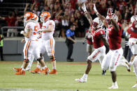 North Carolina State players, right, run on to the field after they defeated Clemson in double overtime at an NCAA college football game in Raleigh, N.C., Saturday, Sept. 25, 2021. (AP Photo/Karl B DeBlaker)