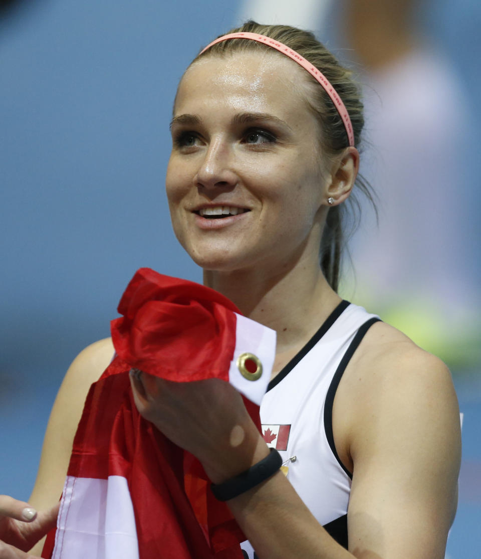 Canada's Brianne Theisen Eaton celebrates after finishing second in the women's pentathlon during the Athletics World Indoor Championships in Sopot, Poland, Friday, March 7, 2014. (AP Photo/Petr David Josek)