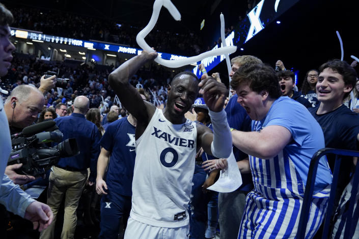 Xavier Musketeers guard Souley Boum (0) celebrates with fans after defeating Marquette in an NCAA college basketball game, Sunday, Jan. 15, 2023, in Cincinnati. (AP Photo/Jeff Dean)