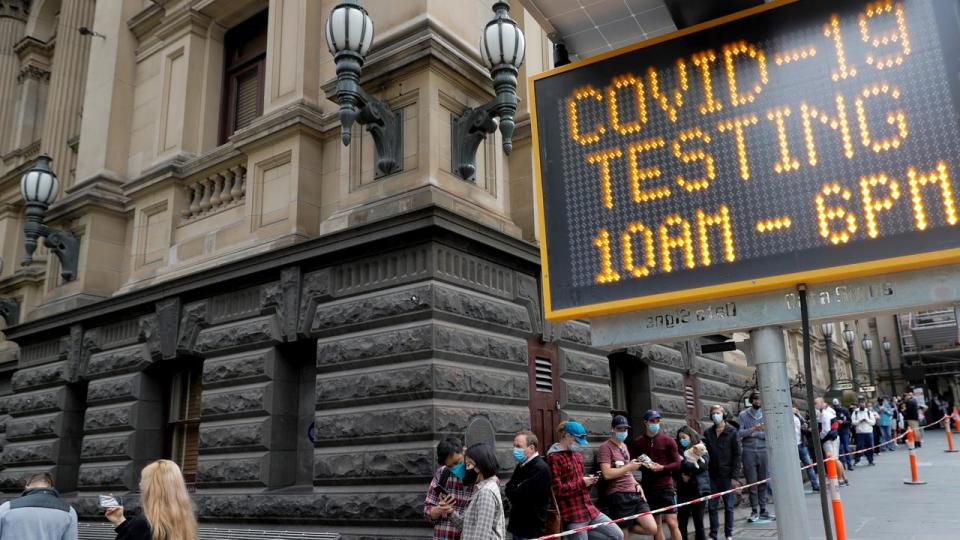 People wait for their COVID-19 test at Melbourne City Hall.