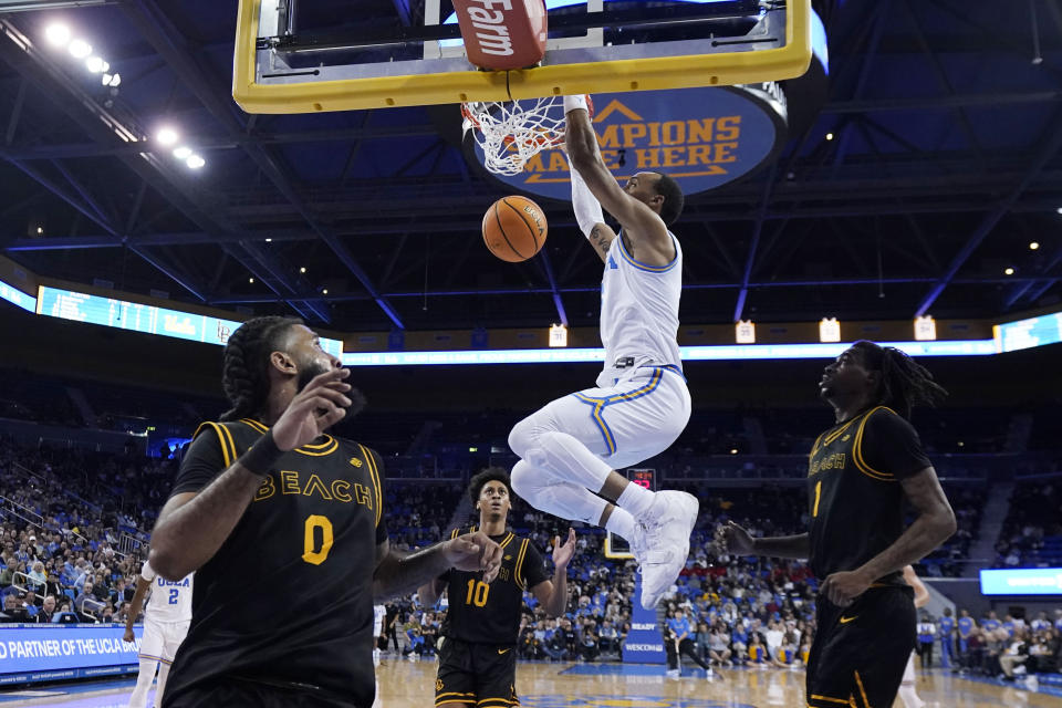 UCLA guard Amari Bailey dunks against Long Beach State during the first half of an NCAA college basketball game Friday, Nov. 11, 2022, in Los Angeles. (AP Photo/Marcio Jose Sanchez)