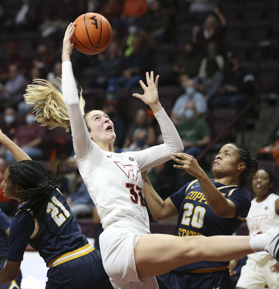 Virginia Tech's Elizabeth Kitley (33) grabs an offensive rebound over Coppin State's Colleen Bucknor (21) and Jaia Alexander (20) during in the first half of an NCAA college basketball game in Blacksburg Va., Wednesday, Nov. 17 2021. (Matt Gentry/The Roanoke Times via AP)