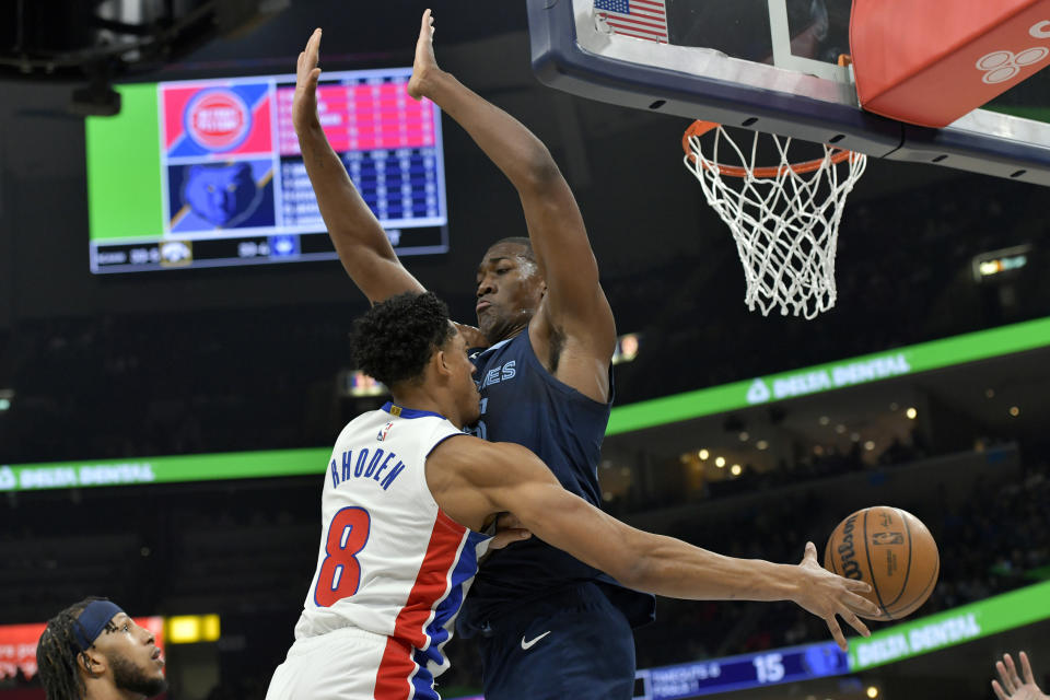 Detroit Pistons guard Jared Rhoden (8) passes around Memphis Grizzlies center Trey Jemison in the first half of an NBA basketball game Friday, April 5, 2024, in Memphis, Tenn. (AP Photo/Brandon Dill)