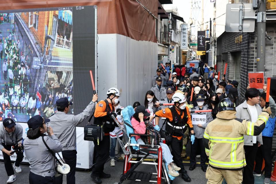 People take part in a drill, conducted by the police, on a street in Seoul, 25 October 2023 (EPA)