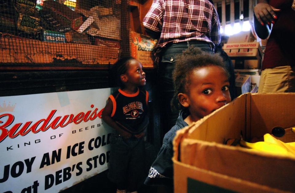 In this 2006 photo, 1-year-old Kelsey Williams (right) entertains himself while waiting with brother Casey for his aunt to finish shopping at Debs Store.