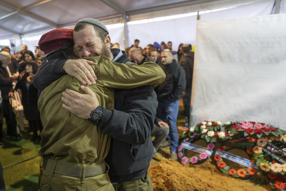 Mourners attend the funeral of reservist Gavriel Shani during his funeral at Mt. Herzl military cemetery in Jerusalem, Wednesday, Jan. 31, 2024. Shani, 28, was killed during Israel's ground operation in the Gaza Strip, where the Israeli army has been battling Palestinian militants in the war ignited by Hamas' Oct. 7 attack into Israel. (AP Photo/Ohad Zwigenberg)