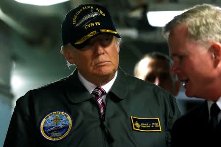 U.S. President Donald Trump tours the pre-commissioned U.S. Navy aircraft carrier Gerald R. Ford with Commanding Officer U.S. Navy Captain Rick McCormack (R) at Huntington Ingalls Newport News Shipbuilding facilities in Newport News, Virginia, Virginia, U.S. March 2, 2017. REUTERS/Jonathan Ernst