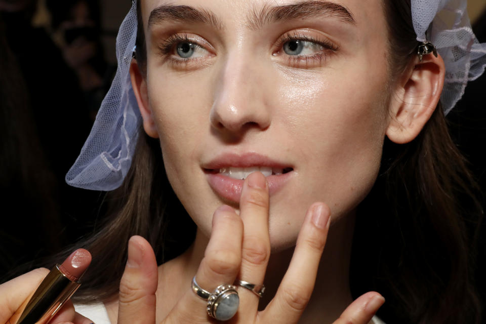 NEW YORK, NEW YORK - FEBRUARY 11: A model has makeup applied backstage at MERIT, The Official Makeup Sponsor For The Proenza Schouler Show on February 11, 2022 in New York City. (Photo by Astrid Stawiarz/Getty Images for MERIT)