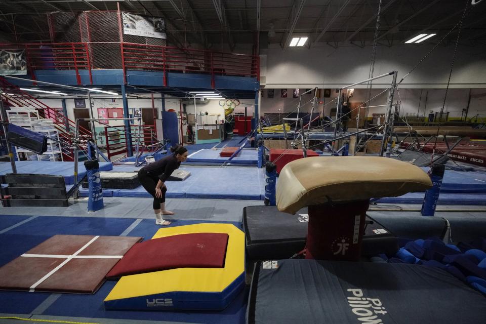 Former gymnastics world champion and Olympic silver medalist Chellsie Memmel works out Thursday, Feb. 18, 2021, in New Berlin, Wisc. Memmel rediscovered her love for the sport, so much so the married mother of two is making an unlikely comeback. (AP Photo/Morry Gash)