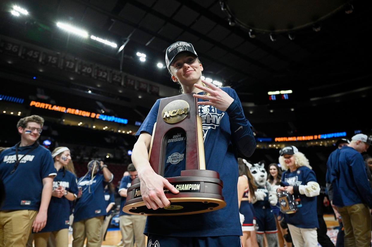 Paige Bueckers holds the championship trophy after UConn beat Southern California in the Portland Regional final.