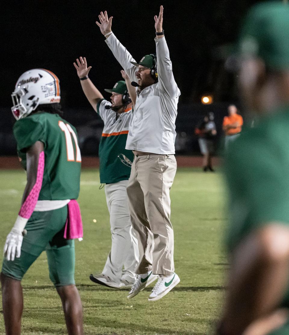 Dolphin head coach Tommy Joe Whiddon gets excited and gets off the ground in the final seconds of the game. Mosley hosted Rickards at Tommy Oliver Stadium Friday, October 15, 2021. The Dolphins came away winners 28-13 to keep their perfect season alive.