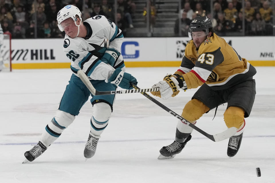 San Jose Sharks left wing Fabian Zetterlund (20) passes around Vegas Golden Knights center Paul Cotter (43) during the first period of an NHL hockey game Friday, Nov. 10, 2023, in Las Vegas. (AP Photo/John Locher)