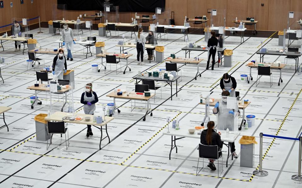 Students at Hull University take swabs for lateral flow Covid-19 tests at the campus sports facilities - AFP