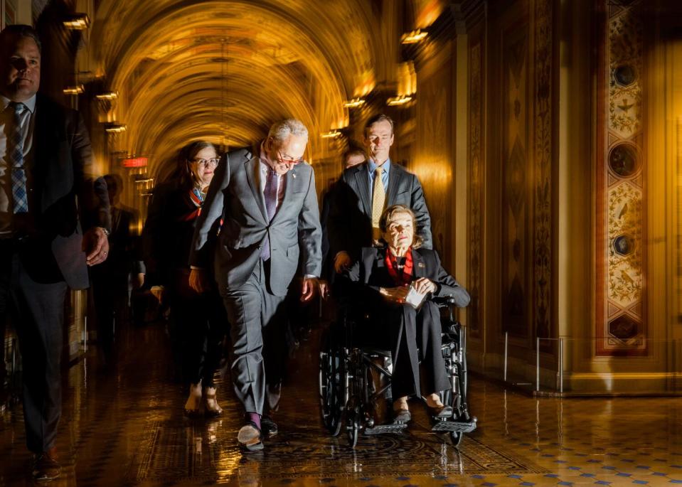 Dianne Feinstein (D-CA) is escorted by Senate Majority Leader Chuck Schumer (D-NY), into the Senate