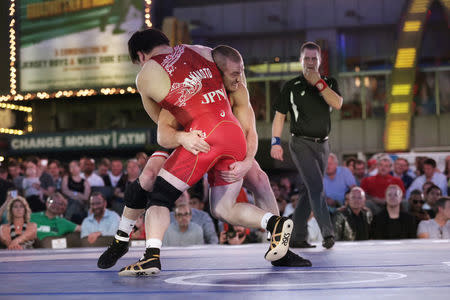 U.S. wrestler Kyle Snyder spars with Japanese wrestler Koki Yamamoto at the "Beat The Streets" wrestling event in Times Square, New York City, U.S., May 17, 2017. REUTERS/Joe Penney