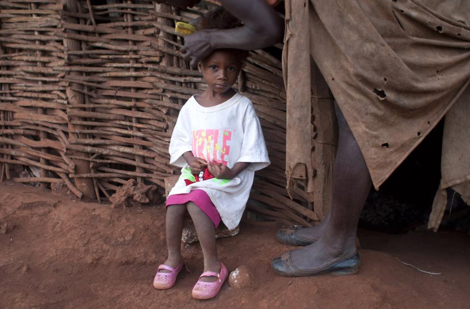 In this Wednesday, March 26, 2014 photo, Jeanilia Jean-Baptiste 38, combs her 3-year-old daughter's hair in preparation for pre-school in Bombardopolis, Haiti. Drought is hitting this region, one of the hungriest, most desolate parts of the most impoverished nation in the hemisphere. Jean-Baptiste said she received a $35 government handout in September. “I spent the money on school tuition, shoes for my children but it wasn’t enough,” she said. (AP Photo/Dieu Nalio Chery)