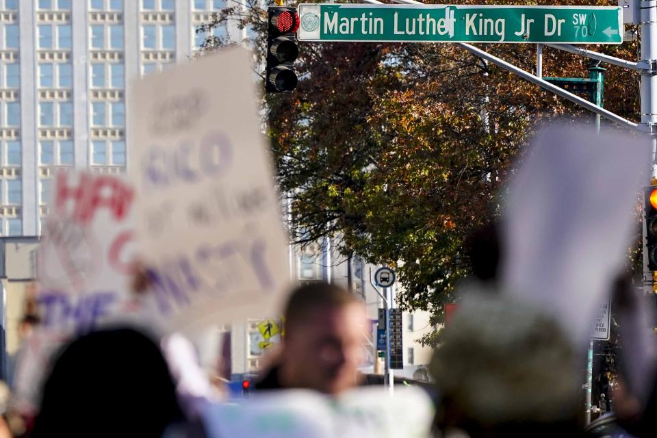 Demonstrators protest 61 defendants that are being arraigned on RICO charges related to vandalism at the site of the new Public Safety Training Center, outside the a Fulton County courthouse, Monday, Nov. 6, 2023, in Atlanta. (AP Photo/Mike Stewart)