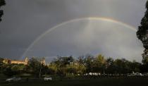 A rainbow is seen over the Union Building, where the body of former South African President Nelson Mandela was lying in state, in Pretoria December 12, 2013. Thousands of people lined up on Wednesday to say goodbye to Mandela, whose body lay in state in the building where the anti-apartheid hero was inaugurated in 1994 as South Africa's first black president. REUTERS/Thomas Mukoya (SOUTH AFRICA - Tags: OBITUARY POLITICS TPX IMAGES OF THE DAY)