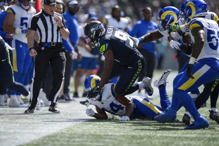 Seattle Seahawks running back Kenneth Walker III (9) is tackled by the Rams defense in the season opener.