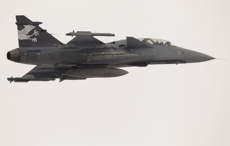 A Swedish Saab Gripen F fighter flies over the Swiss Army Airbase in the central Swiss town of Emmen January 17, 2013. REUTERS/Arnd Wiegmann