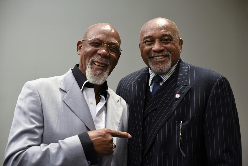 FILE - In this Sept. 28, 2016, file photo, John Carlos, left, and Tommie Smith pose for a portrait at Georgetown University in Washington. When Smith and Carlos raised their fists 50 years ago at the Mexico City Olympics, they had a captive audience, back in the age when TV was king and the entire audience was rapt. A half-century later, many of the messages our athletes disseminate are every bit as powerful, but the audience is much more distracted. (AP Photo/Sait Serkan Gurbuz, File)