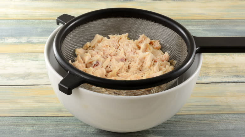 Canned tuna in a mesh strainer 