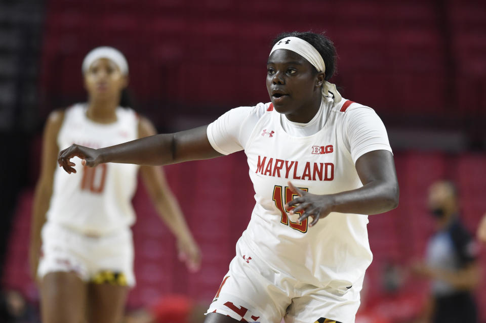 Maryland's Ashley Owusu, right, defends against UNC Wilmington during the first half of an NCAA college basketball game on Thursday, Nov. 18, 2021, in College Park, Md. (AP Photo/Gail Burton)