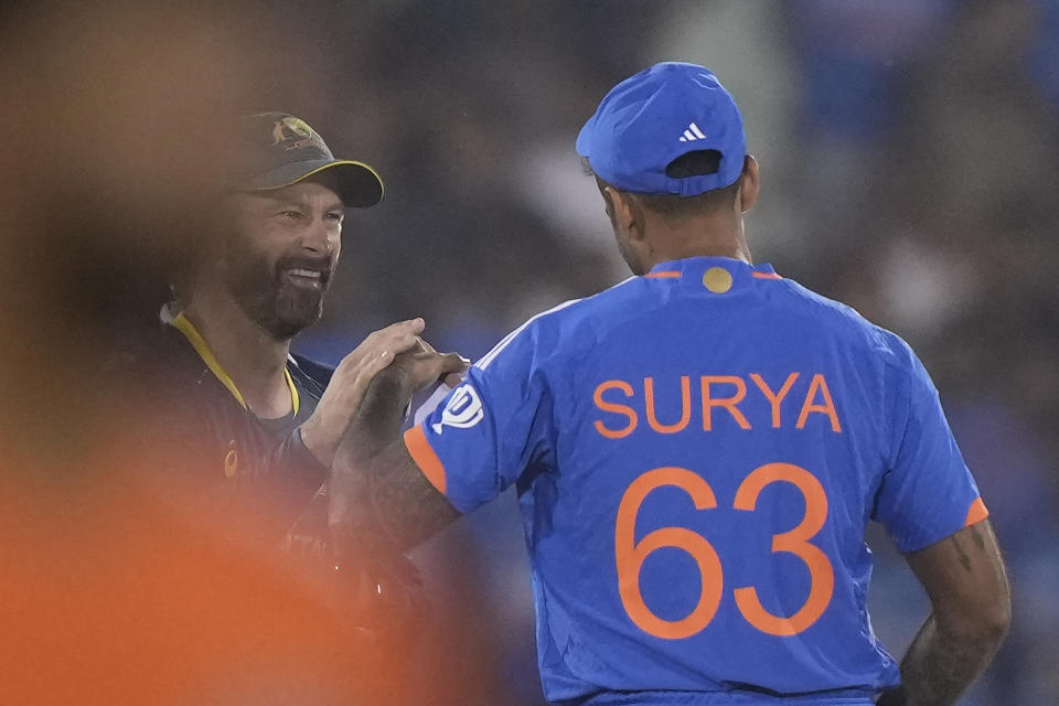 Australia's captain Matthew Wade and India's captain Suryakumar Yadav share a light moment before the start of the fourth T20 cricket match between Australia and India in Raipur, India, Friday, Dec. 1, 2023. (AP Photo/Mahesh Kumar A.)