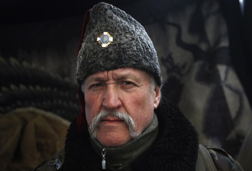 A Cossack poses for a picture in a demonstrators' camp during a rally held by anti-government protesters in Independence Square in central Kiev