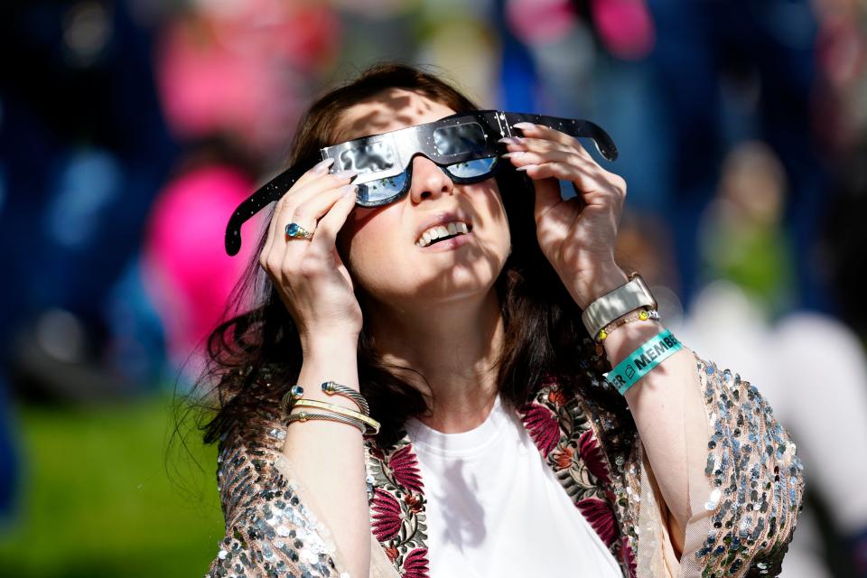 Alicia Ficalora, of Scarsdale, New York, looks at the solar eclipse from Liberty Science Center, Monday, April 8, 2024, in Jersey City.