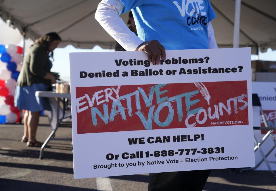 Attorney Diane Enos checks with voters to see if they had any problems casting their ballot at the Salt River Tribal Recreation Center in Scottsdale, Arizona, Tuesday morning.