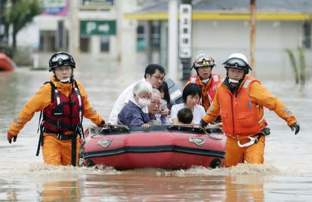 Local residents sit in a boat as they are rescued from a flooded area at a hospital in Kurashiki, Okayama Prefecture, Japan, in this photo taken by Kyodo July 8, 2018. Mandatory credit Kyodo/via REUTERS