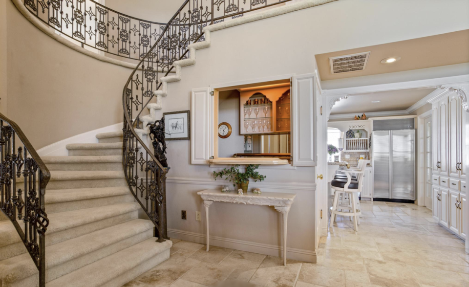 The spiral staircase and wet bar first greet visitors.