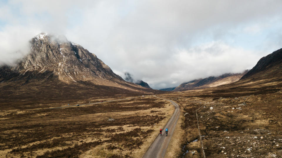 Two riders on the West Highland Way entering Glencoe, with Buachaille Etive Mor in background